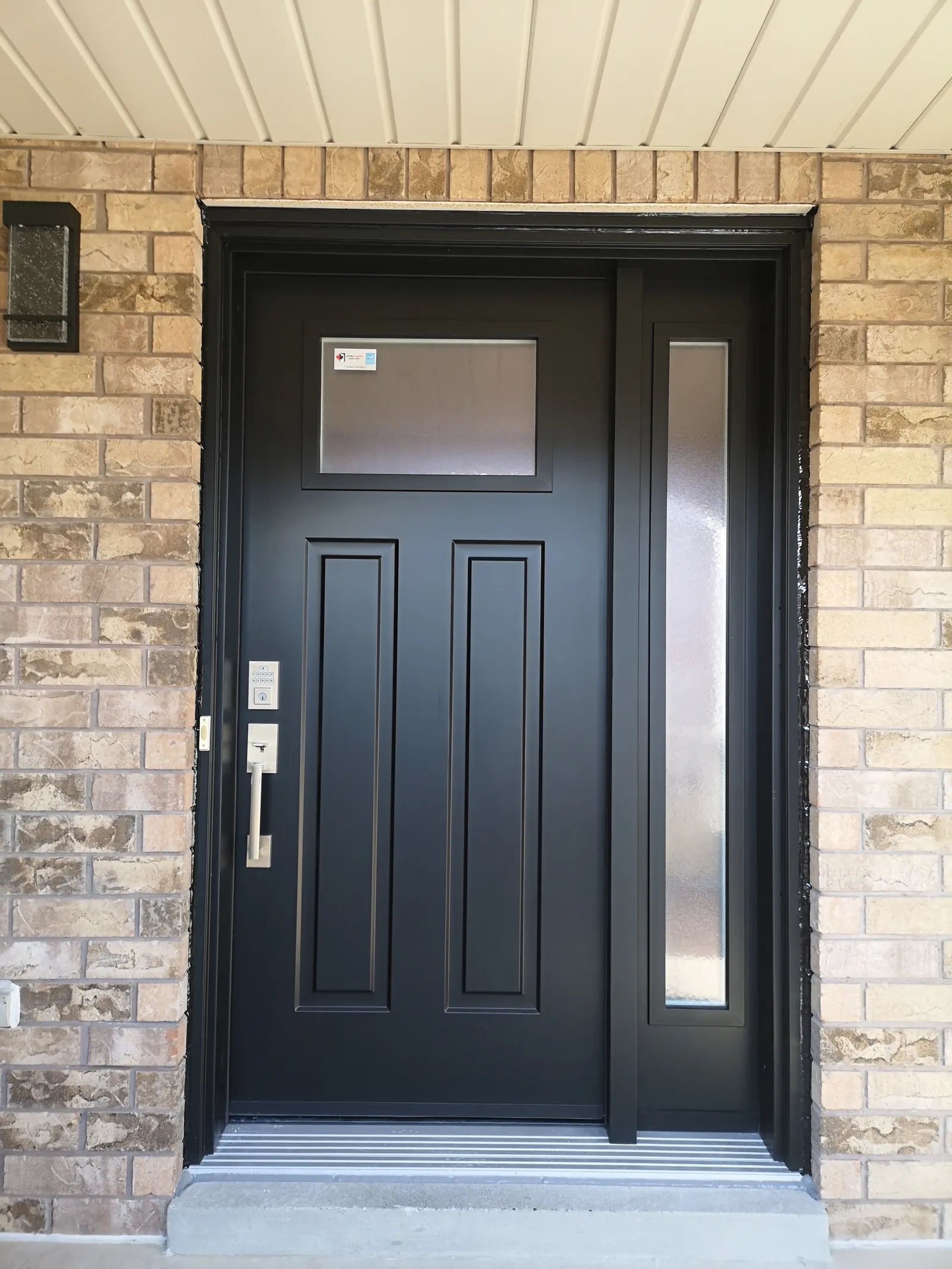 Black craftsman door with sidelite