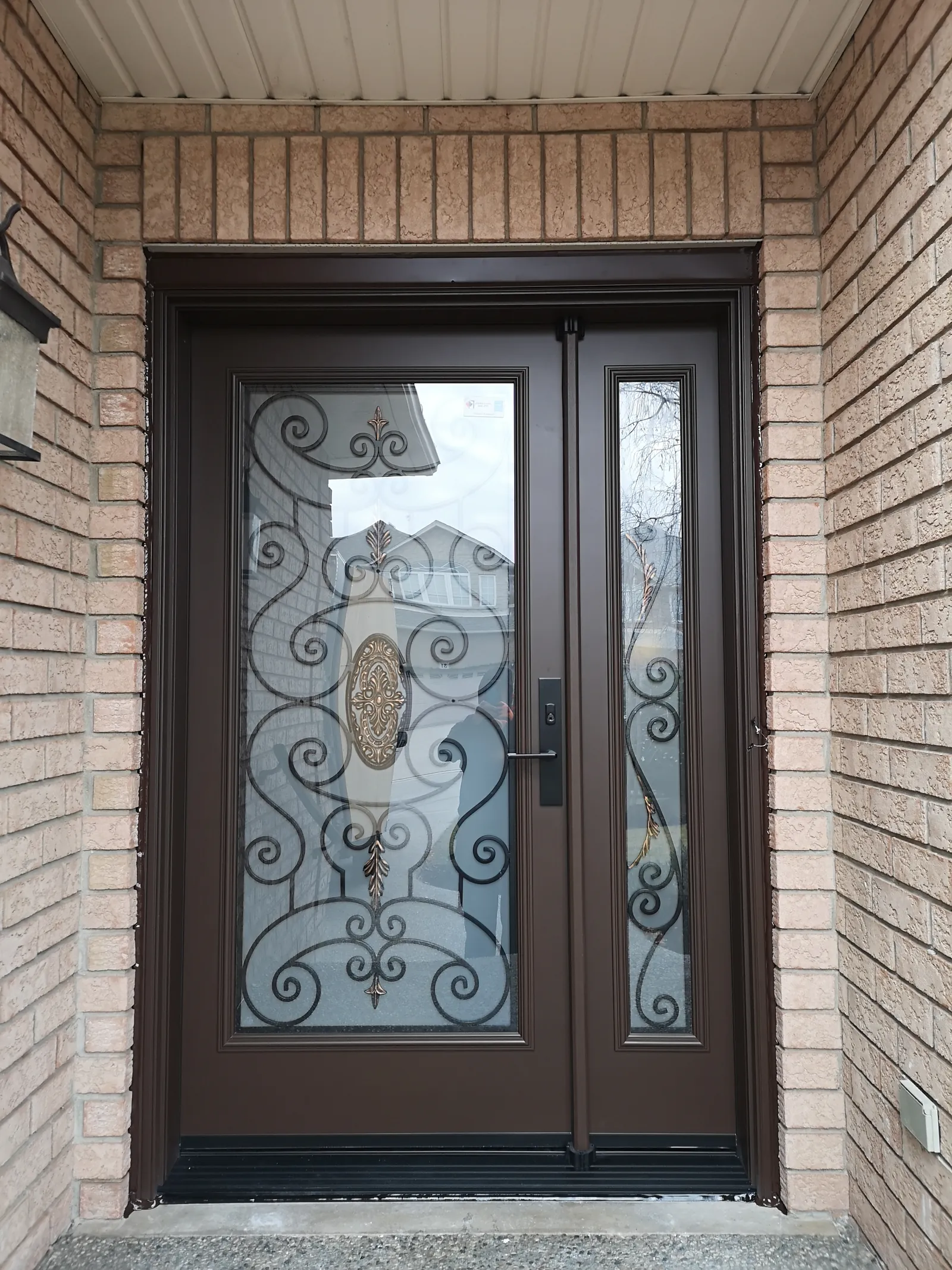 Brown door with wrought-iron glass