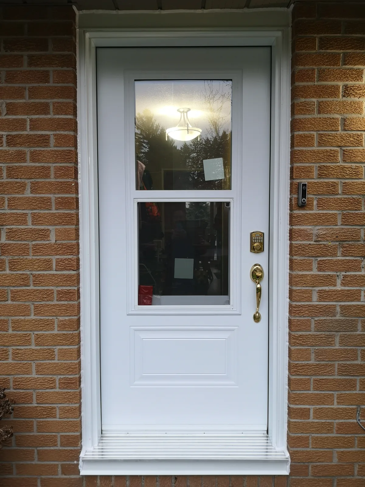 White half-lite door with brass hardware
