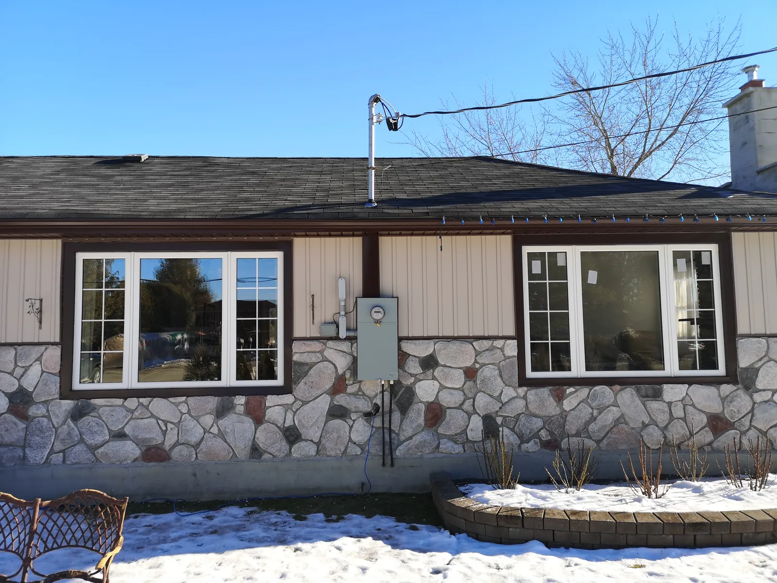 New windows across a stone-front home