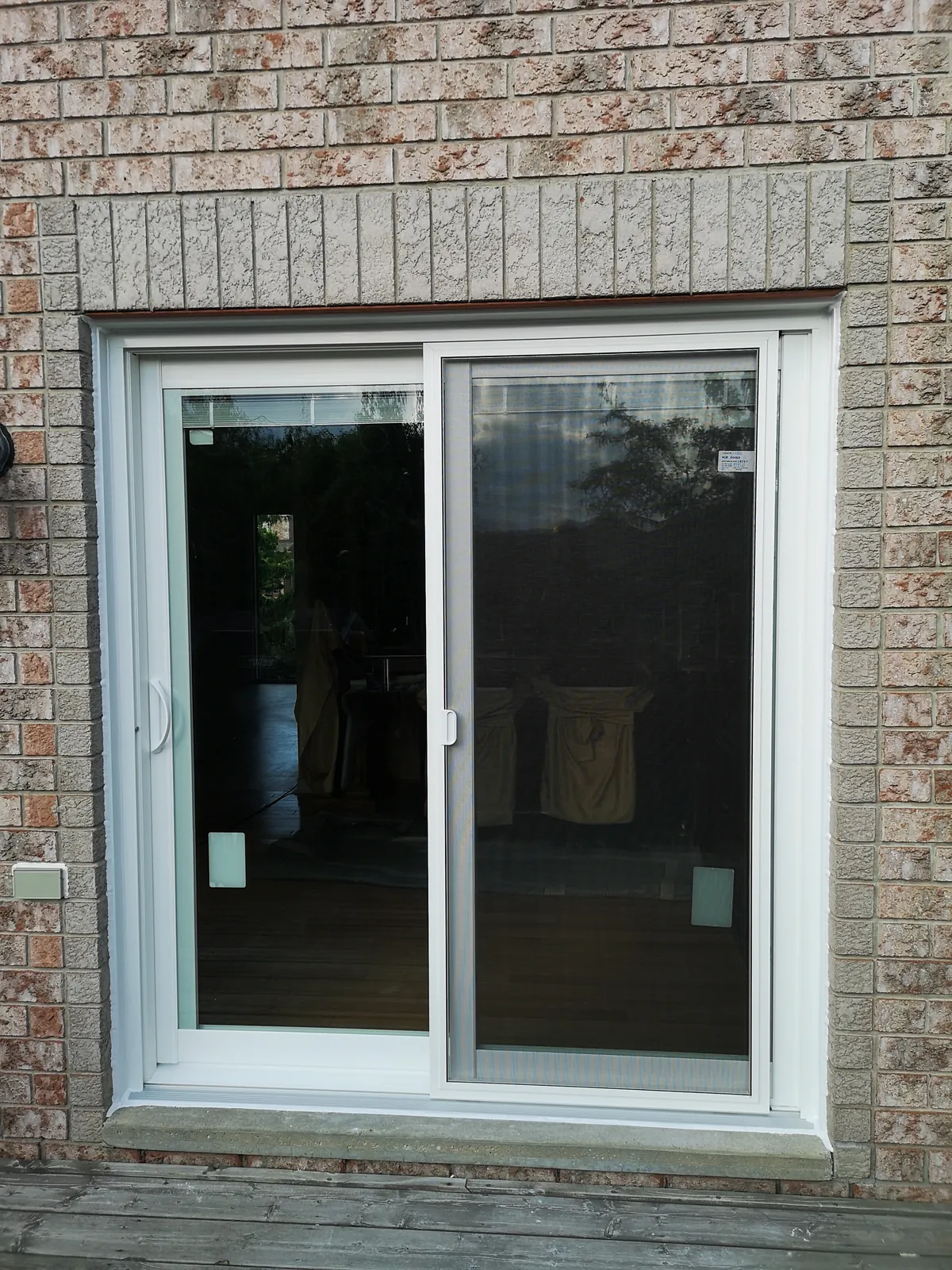 White sliding patio door, brick exterior