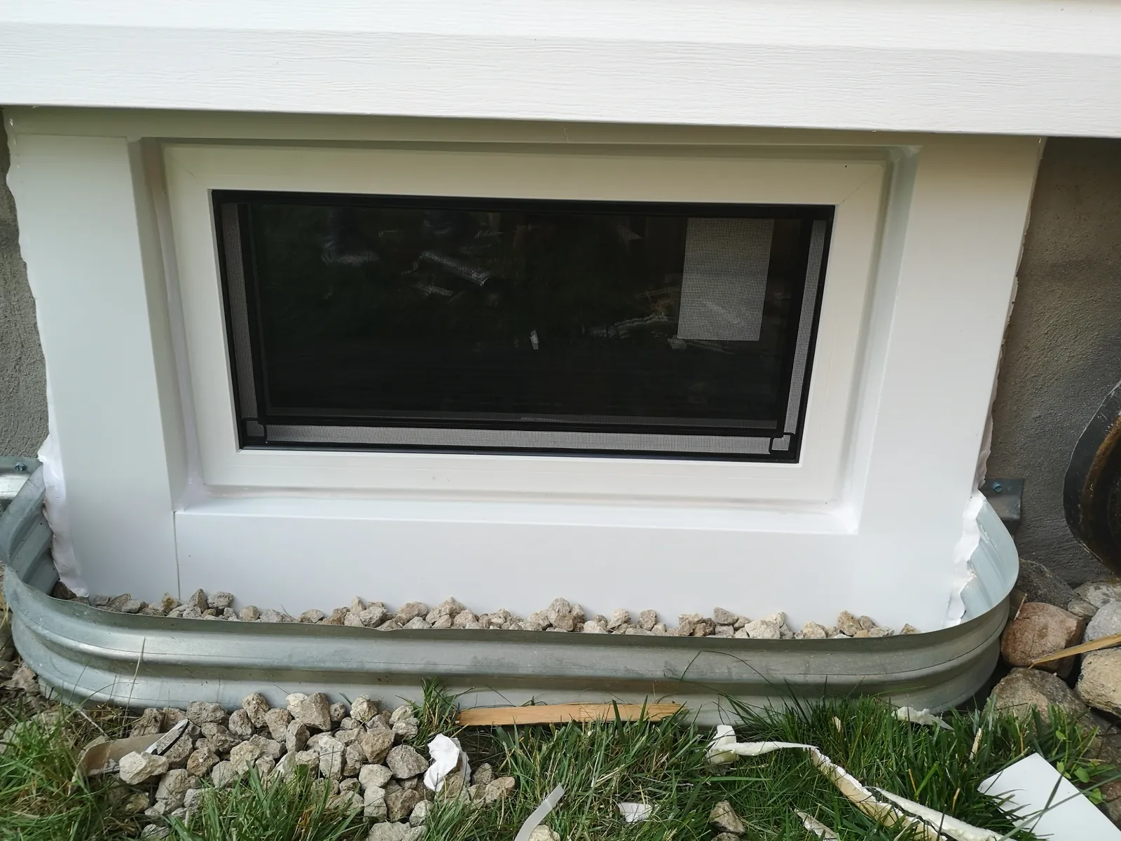 Cream triple picture window, vinyl siding