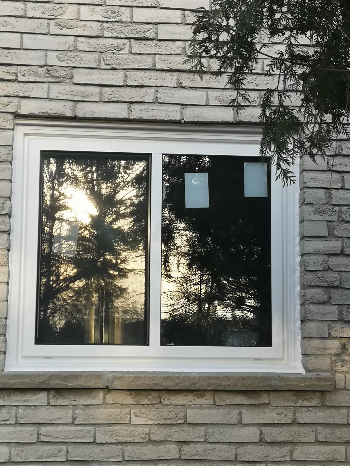White slider window, grey brick
